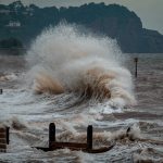 sea waves crashing on shore during daytime